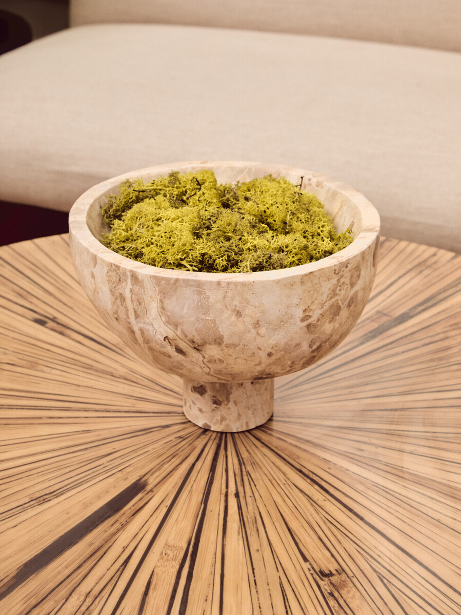 Chocolate marble pedestal bowl with natural veining and a round elevated base.