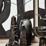 Black marble pyramid ornament with white veining, offering a sleek and contemporary aesthetic for modern interiors.