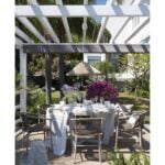 IVORY Round Wooden Outdoor Dining Table. Garden Image