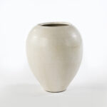 Small cream-colored terracotta vase with ovoid shape and artisanal finish. Shop luxury Terracotta at Louis & Henry