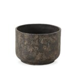 Small cylindrical planter in burnt black fibre cement with a textured, weathered surface