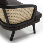 Dark fabric two-seat sofa with natural rattan accents and a modern, compact design