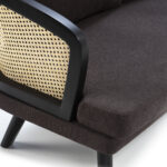 Dark fabric two-seat sofa with natural rattan accents and a modern, compact design