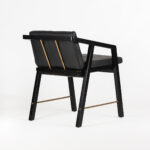 OLSEN Teak and Leather Armchair with a black teakwood frame, gold metal support bars, and premium black leather upholstery, measuring 51x54x70 cm.