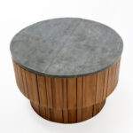 ÉMILE Coffee Table with a two-tiered cylindrical teak wood base and natural stone top. Shop now at Louis & Henry