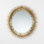 Oval-shaped central mirror with a stepped sunray frame in rich gold metallic finish, inspired by Art Deco design.