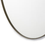 Large circular mirror with slim gold frame against white background