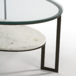 Oval glass coffee table with black metal frame and marble lower shelf