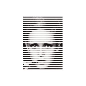 Black and white methacrylate wall art featuring a large image of a face with intense, staring eyes. The design includes dynamic strips running through the image, creating a dramatic effect.