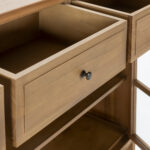 EMERY Natural Cedar Wood and Glass Sideboard with two folding glass doors, two shelves, and three upper drawers, featuring sleek black door knobs.