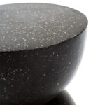 NETHERTON Black Terrazzo Stool with an hourglass shape and intricate terrazzo patterns on a sleek black surface. WWW.LOUISANDHENRY