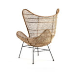 INGLEWOOD Wingback Rattan Armchair with bowl-shaped seat, natural woven rattan, and black metal base.