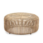 Round whitewashed rattan pouf with intricate open-weave design, suitable for bohemian, coastal, or modern interiors.