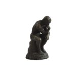 Miniature bronze sculpture of Rodin’s Thinking Man, resting on a marble base, symbolizing philosophical contemplation.