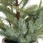 CHRISTMAS IMAGE Handcrafted GARDA Pine Tree in a rustic stone pot, perfect as a festive tabletop centerpiece.