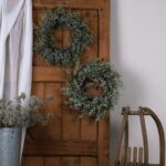 Snowy Pine Wreath with realistic pinecones and snow-dusted branches for festive décor.