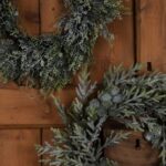 CHRISTMAS IMAGES. Snowy Pine Wreath with realistic pinecones and snow-dusted branches for festive décor.