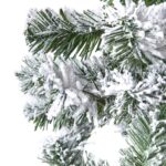 Extra large snow-dusted spruce tree with realistic branches for a holiday display.