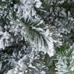 Extra large snow-dusted spruce tree with realistic branches for a holiday display.