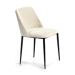 ARIS Dining Chair in cream upholstery with black metal legs and a curved backrest.