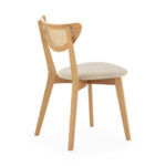 LEXY Natural Rattan and Wood Dining Chair with light wood frame, rattan backrest, and beige fabric seat.