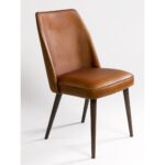 JACKY buffalo leather dining chair with dark wooden legs and minimalist industrial design.