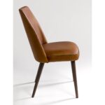 JACKY buffalo leather dining chair with dark wooden legs and minimalist industrial design.