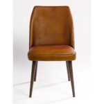 JACKY buffalo leather dining chair with dark wooden legs and minimalist industrial design.