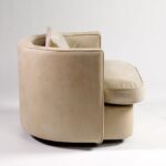 BELVOIR Off-White Leather Armchair with semicircular backrest, black metal frame, and plush cushions for modern interiors.