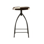 FORGE Barstool with a black metal frame and round brown and white cowhide upholstered seat, combining rustic and industrial style.