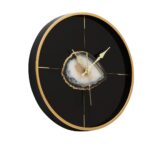 SAUL Clock with a sleek black face, gold accents, and minimalist design, ideal for modern interiors.