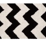 CAIN Rug with bold black and white chevron pattern, perfect for living rooms or hallways.