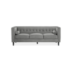 ELI Sofa with grey velvet upholstery, button-tufted backrest, bolster pillows, and black slanted oak legs, designed as a three-seat sofa.