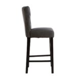 SABINA Charcoal Barstool with soft charcoal fabric upholstery, diamond-button backrest, sturdy black rubberwood legs, and sleek metal footrests.