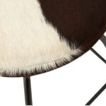 FORGE Barstool with a black metal frame and round brown and white cowhide upholstered seat, combining rustic and industrial style.