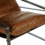 BASTIEN Tan Lounge Chair with light brown distressed leather, cushioned backrest, tonal stitching, and sleek metallic frame for a modern industrial look.