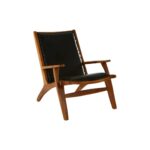 JOEY Chair with sculpted teak wood frame, plain black leather upholstery, stud detail, and mid-century modern architectural design.