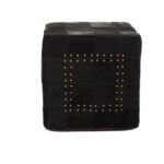 MILO Pouffe with black cowhide leather patchwork design and metallic stud details, perfect as a stylish and versatile accent piece.
