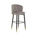 RUNE Barstool with grey velvet upholstery, cushioned seat, curved backrest, and sleek black legs with gold-tipped accents.