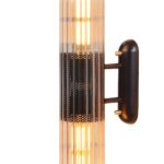 Vertical wall light with a solid brass and glass construction, black and brushed brass finish, featuring two E27 sockets for ambient illumination.