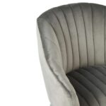 Modern armchair with monochromatic channel-tufted upholstery, sloping armrests, and angled silver-finished wooden legs.