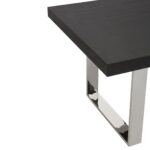 Modern dining table with a black elm wood rectangular top and U-shaped stainless steel legs for an industrial design.