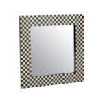 Round wall mirror with a bold black and white mother-of-pearl frame, perfect for adding a modern touch to home decor.