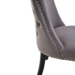 Grey velvet dining chair with button-tufted backrest, stud detailing, and solid black wood legs.