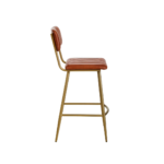 Tan leather barstool with vertical channel tufting and a sleek gold-finished angular iron frame.