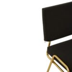 Black linen dining chair with a gold-finished metal frame, square padded backrest, and armless angular design.