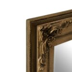 Classic wall mirror with carved motifs, weathered-effect frame, and vintage-inspired design, ideal for traditional or eclectic interiors.