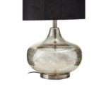 Table lamp with a metallic silver glass base, round metal plate, and black linen shade, perfect for modern interiors.