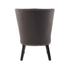 Dark mink velvet dining chair with a wingback design, deep-cushioned seat, black wood legs, and silver stud detailing.