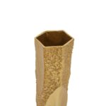 Modern aluminum vase with a warm gold metallic finish, featuring smooth and textured surfaces, an asymmetric design, and a hexagonal top.